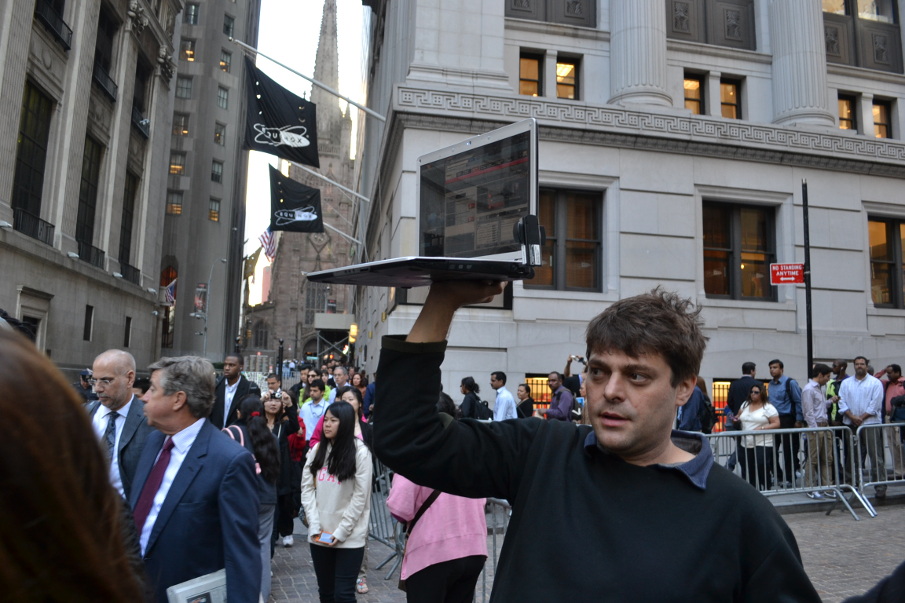 Vlad Teichberg holds up a livestreaming computer during an early Occupy Wall Street march at the New York Stock Exchange.